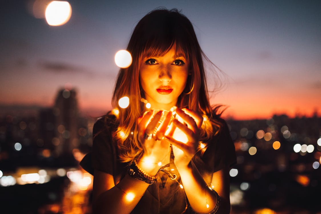 Woman with light in hands